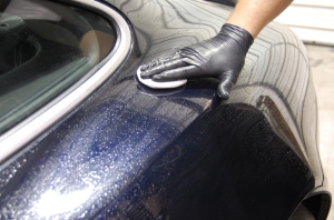 Auto detailing begins with a thorough washing of a car surface.