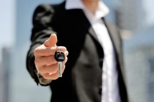 person holding a car key
