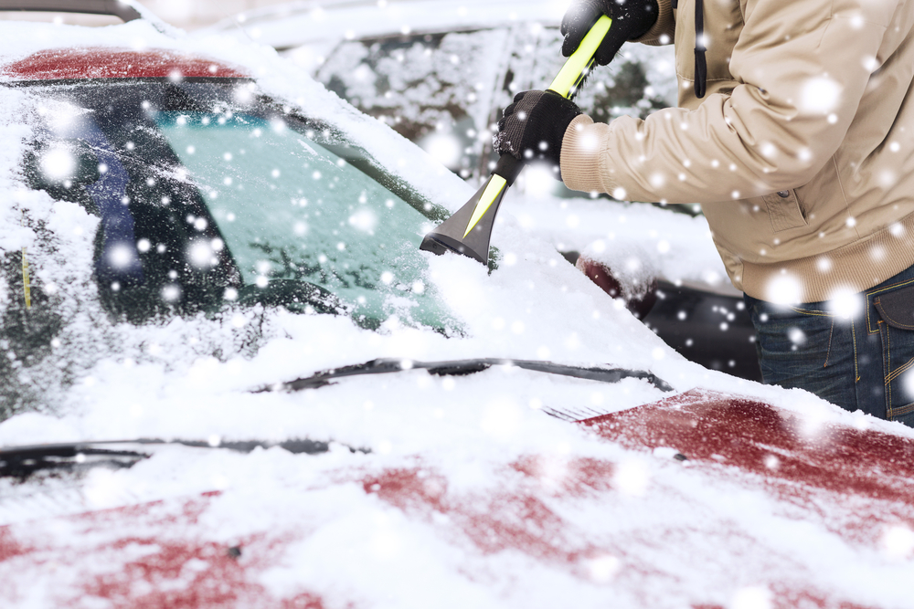 Man scraping ice off car in toronto