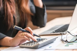 Woman calculating interest rate on bad credit car loan in toronto