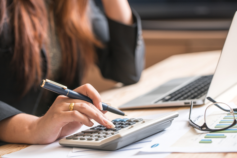 Woman calculating interest rate on bad credit car loan in toronto