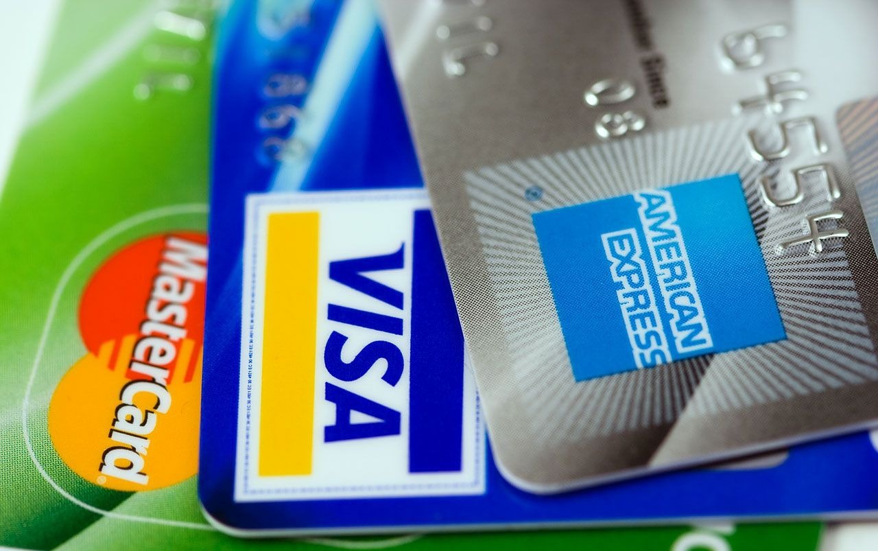 A Visa, a MasterCard, and an AMEX credit card.